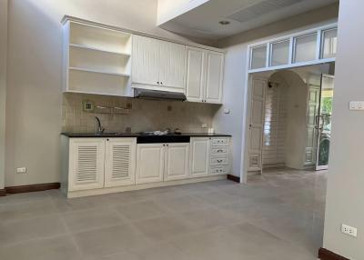 Spacious kitchen with white cabinetry and tiled backsplash