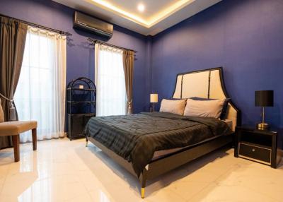 Elegant bedroom with royal blue walls and modern decor