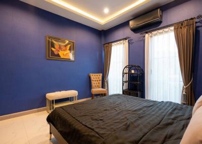 Cozy bedroom with royal blue walls and elegant decor