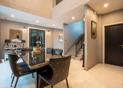 Modern spacious living room with dining area and staircase