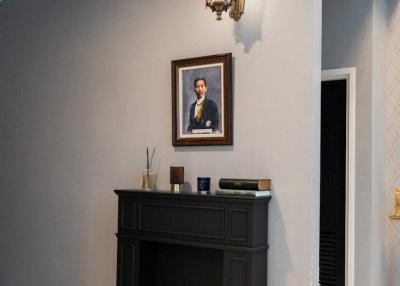Elegant living room corner with decorative fireplace and portrait