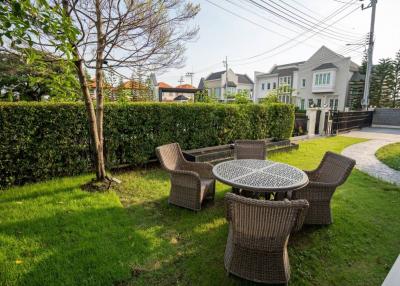 Cozy garden seating area with lush greenery