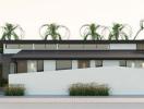 Modern single-story residential home with flat roof and palm trees at dusk