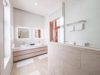 Bright and modern bathroom with double vanity and large mirror