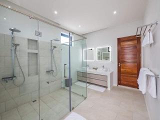 Modern spacious bathroom with glass shower and elegant vanity