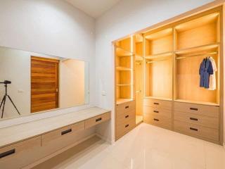 Spacious bedroom with built-in wooden wardrobe and modern design