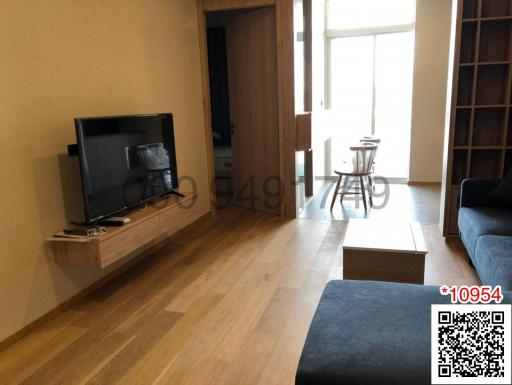 Contemporary living room with television and wooden flooring