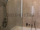 Modern bathroom with glass shower and tiled walls