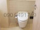 Modern bathroom with wall-mounted toilet and tile flooring