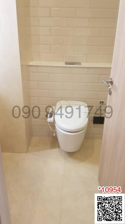 Modern bathroom with wall-mounted toilet and tile flooring