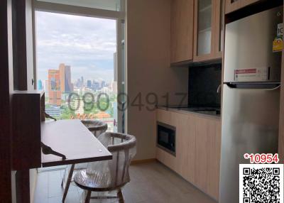 Compact modern kitchen with city view through large windows
