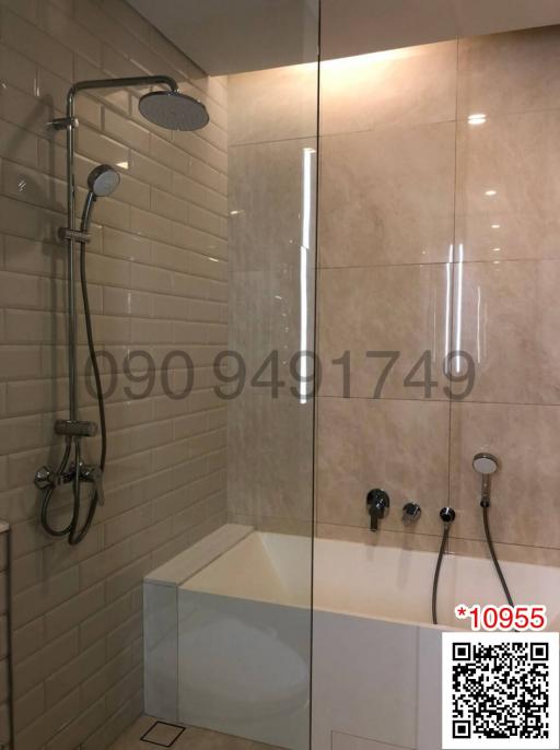 Modern bathroom with glass shower and beige tiles