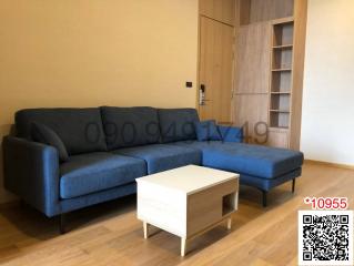 Spacious and modern living room with comfortable blue sofa and wooden furniture