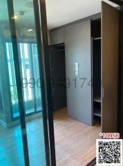 Modern building entrance foyer with glass door and wooden flooring