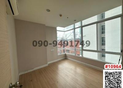 Spacious unfurnished room with large window and hardwood floors