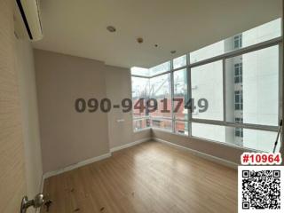 Spacious unfurnished room with large window and hardwood floors