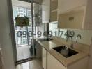 Compact kitchen with modern appliances and balcony access