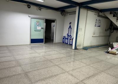 Spacious commercial building interior with tiled floors and ample lighting