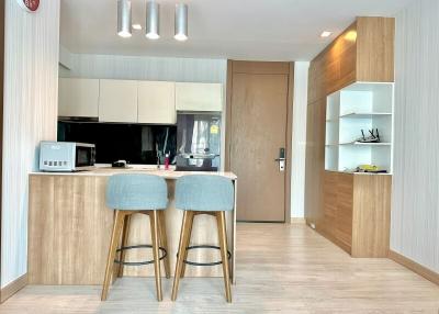 Modern kitchen with bar stools and wooden finishes