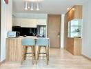 Modern kitchen with bar stools and wooden finishes