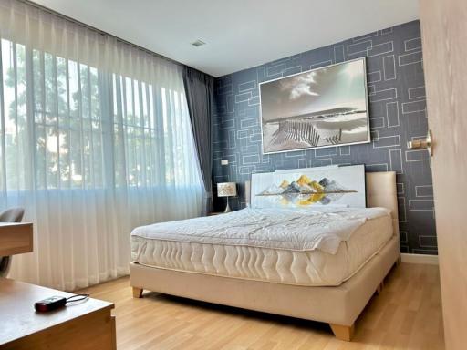 Modern bedroom with large bed and artistic wall decor