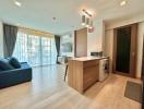 Spacious open plan living room with modern kitchen and ample natural light