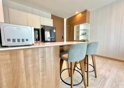 Modern kitchen with a breakfast bar and wooden finishes