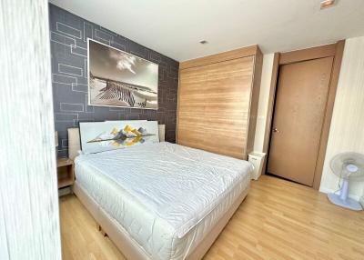 Modern bedroom with large bed and artistic wall design
