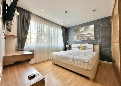 Spacious modern bedroom with large windows and elegant decor