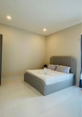 Modern bedroom with a neatly made bed and ambient lighting
