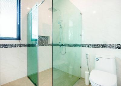 Modern bathroom with walk-in shower and white ceramic toilet
