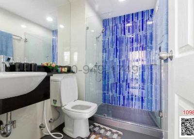 Modern bathroom with glass shower and white fixtures