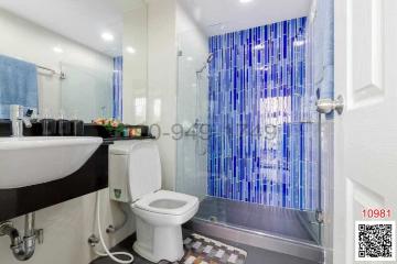 Modern bathroom with glass shower and white fixtures