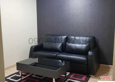 Contemporary living room with a black leather sofa and a modern coffee table