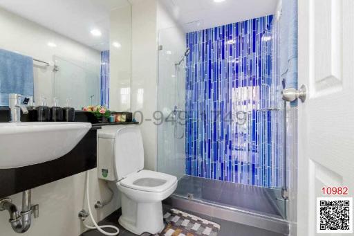 Modern bathroom interior with glass shower and white fixtures