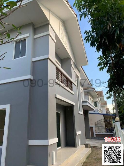 Exterior view of a modern two-story residential building with balcony