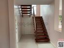 Wooden staircase in a well-lit, modern home interior