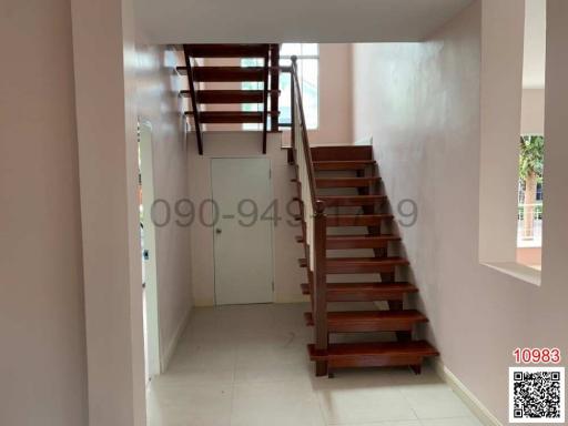 Wooden staircase in a well-lit, modern home interior