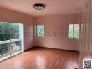 Spacious bedroom with large windows and balcony access in a modern home