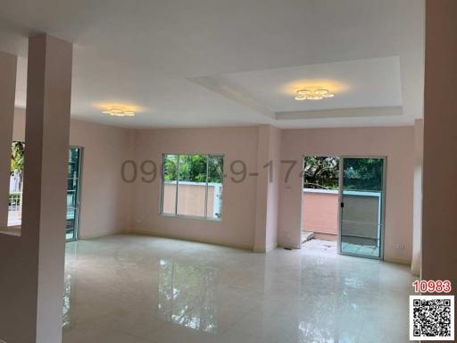 Spacious living room with natural light and balcony access