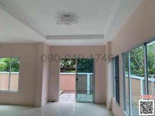 Spacious and bright room with large windows and tiled flooring in a modern building