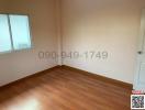 Empty bedroom with hardwood floor and a window