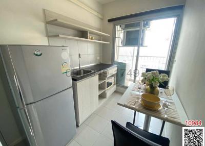Compact modern kitchen with appliances and a dining area