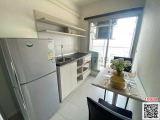 Compact modern kitchen with appliances and a dining area