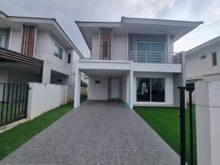 Modern two-story house with driveway and balcony