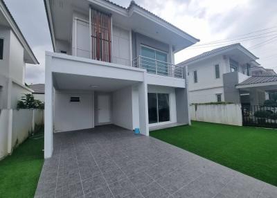 Modern two-story house with spacious front yard and carport