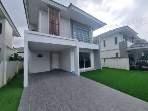 Modern two-story house with spacious front yard and carport