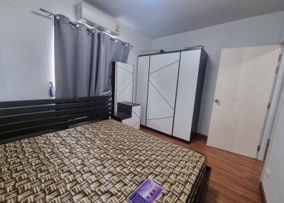 Spacious bedroom with a large bed and ample storage