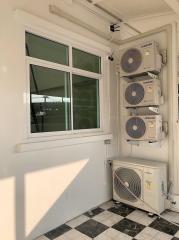 Compact utility area with multiple air conditioning units mounted on the wall