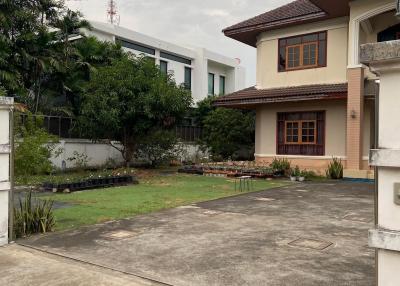 Front view of a two-story residential home with a garden